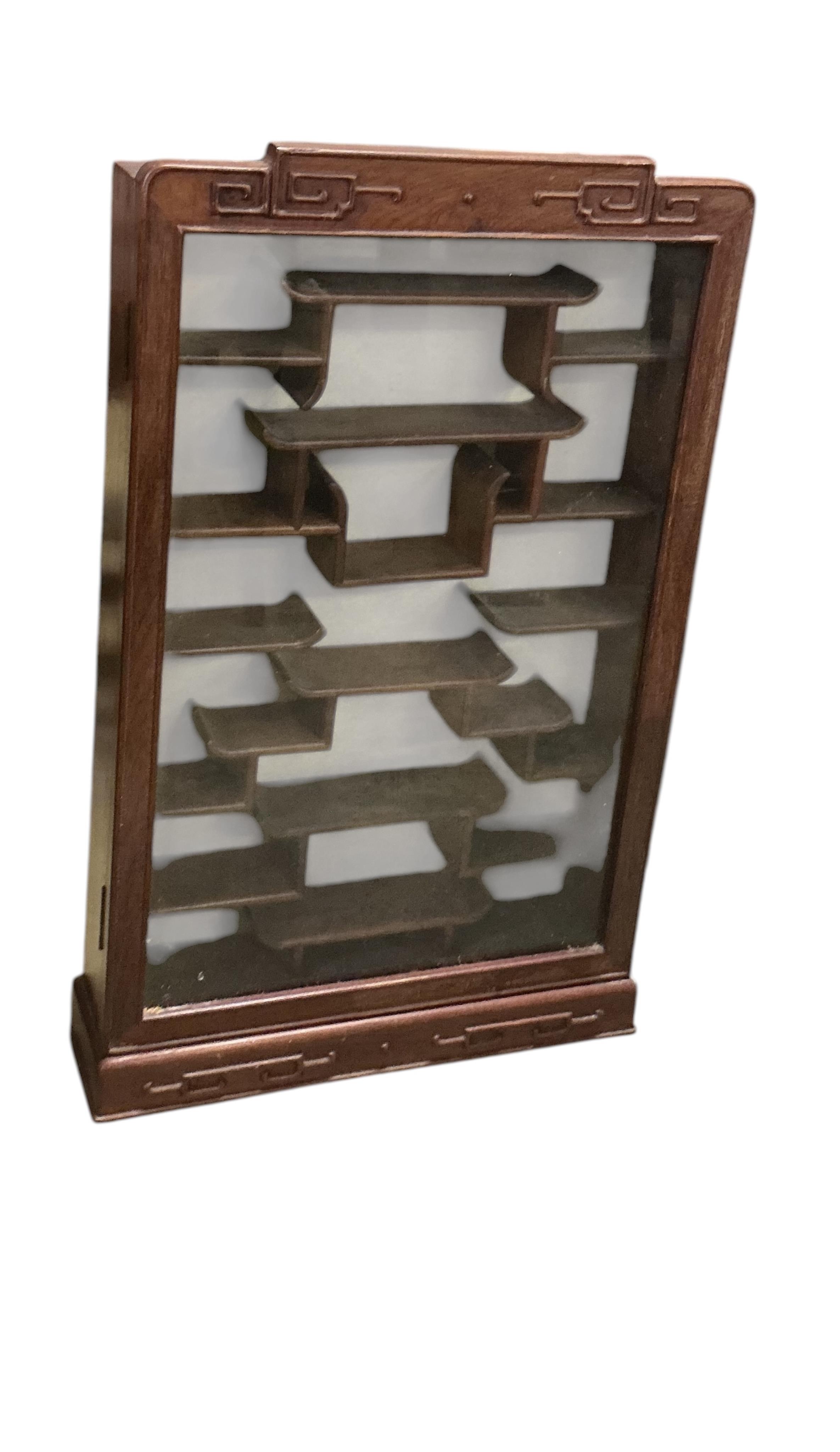 A pair of Chinese carved hardwood wall display cabinets, width 43cm, depth 10cm, height 71cm